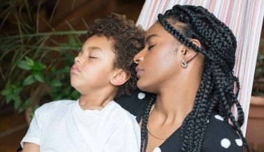 mother and son sleeping on a hammock