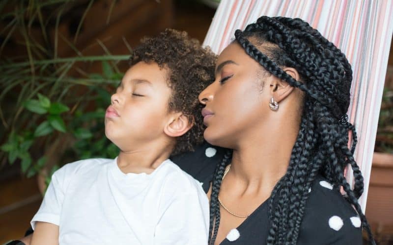 mother and son sleeping on a hammock