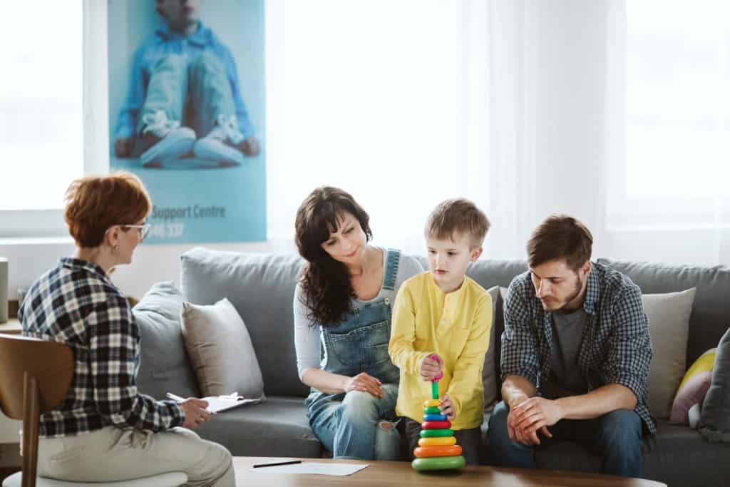 parents and child talking to a therapist
