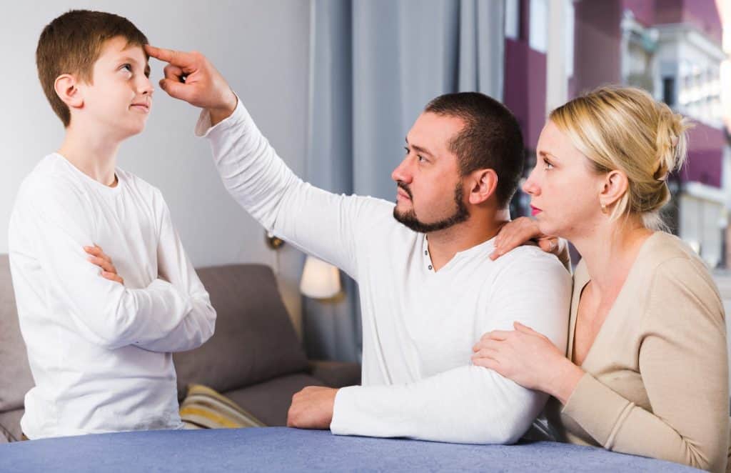 parents disciplining their child