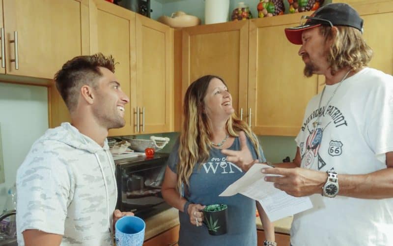 three people talking in a kitchen
