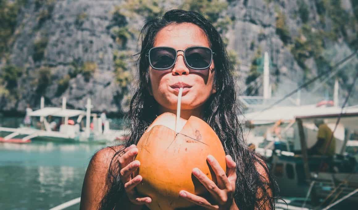 woman drinking coconut juice