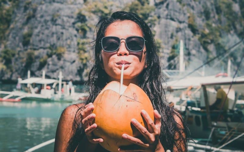 woman drinking coconut juice