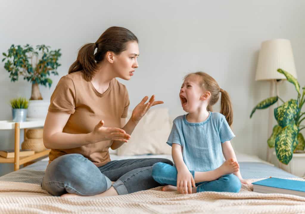 woman talking to a crying child