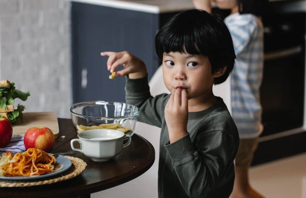 asian boy eating breakfast