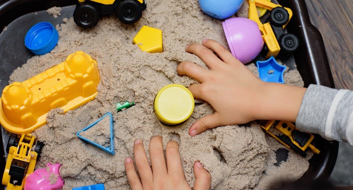 child playing with kinetic sand