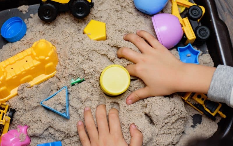 child playing with kinetic sand
