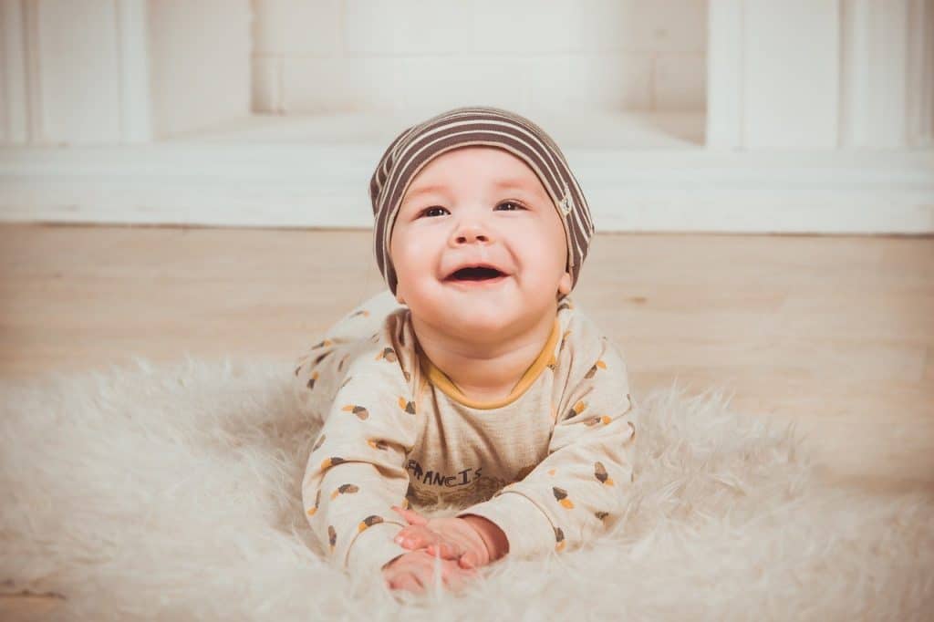 cute baby boy on white carpet