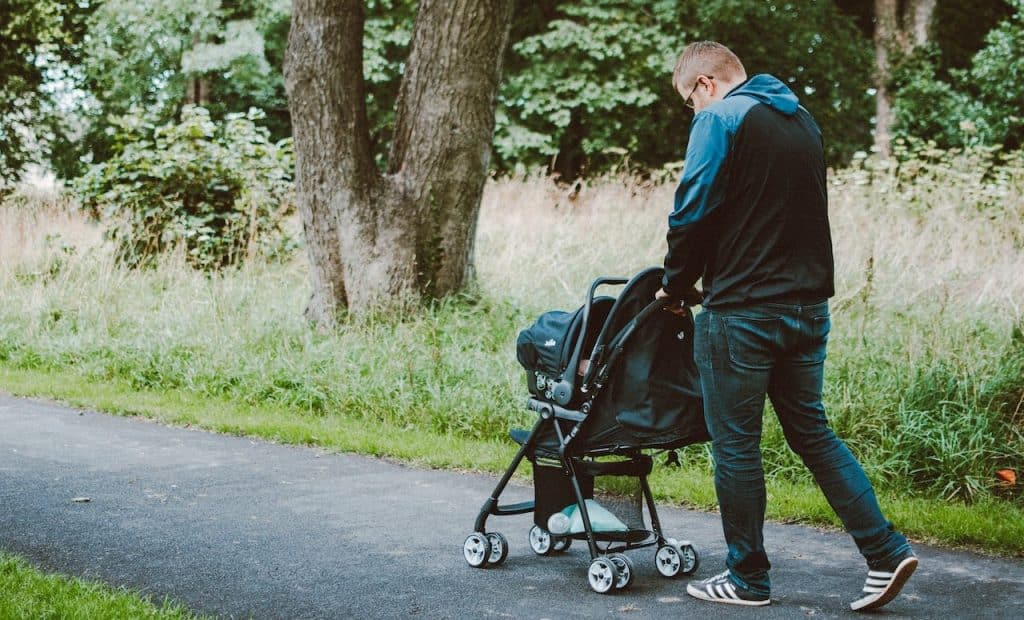 dad pushing baby on stroller