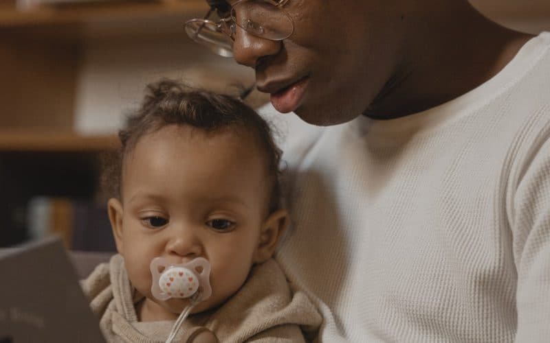 dad reading book to baby