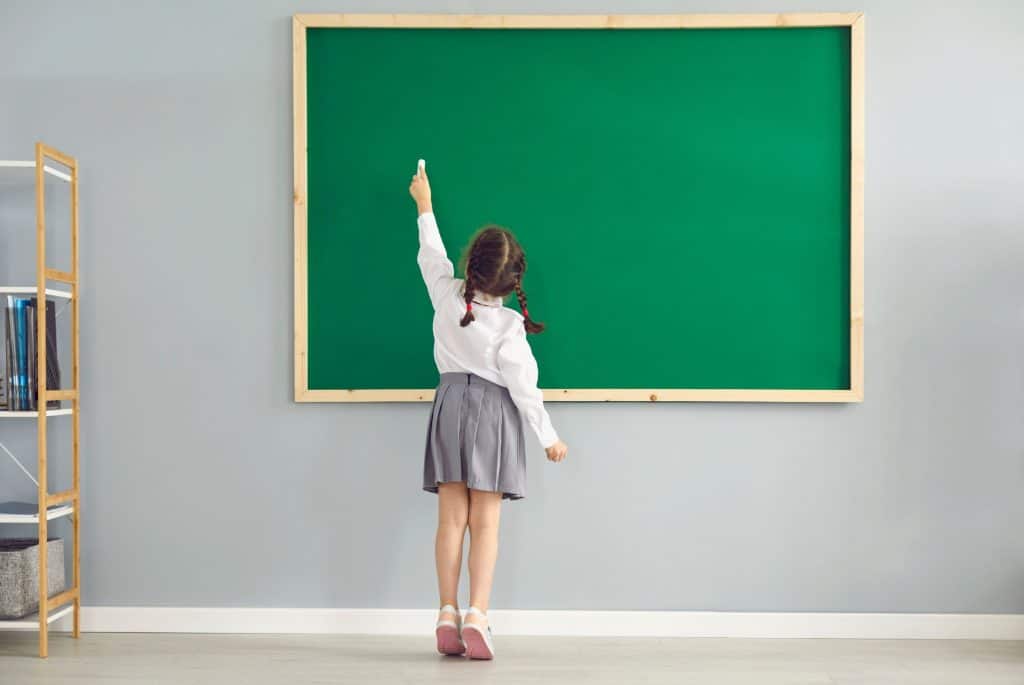 girl writing on a board