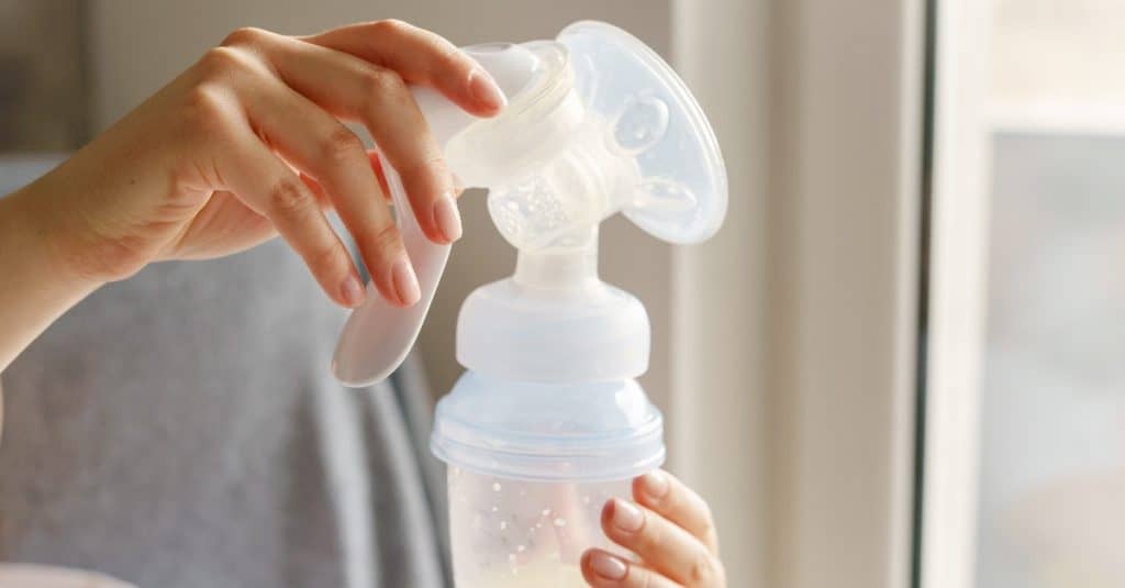 mom holding a breast pump