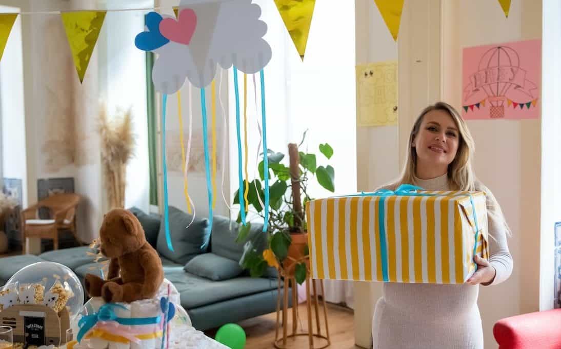 mom holding baby shower gift