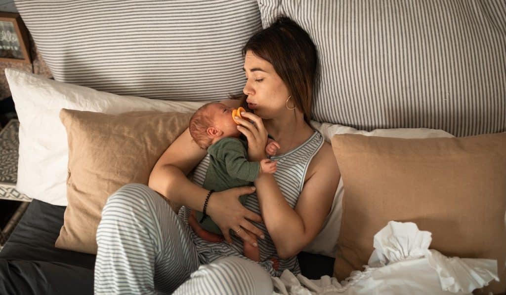 mom on bed with baby