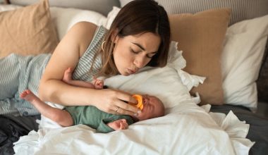 mom putting pacifier on baby
