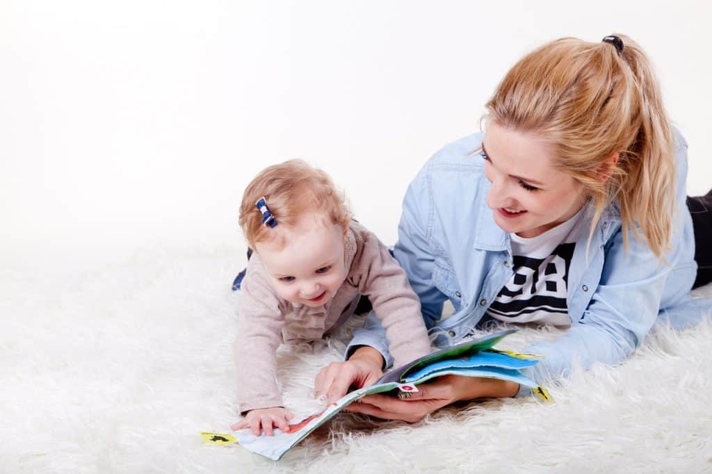 mom reading with baby girl