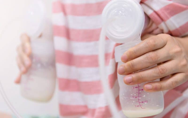 mom using breast pump
