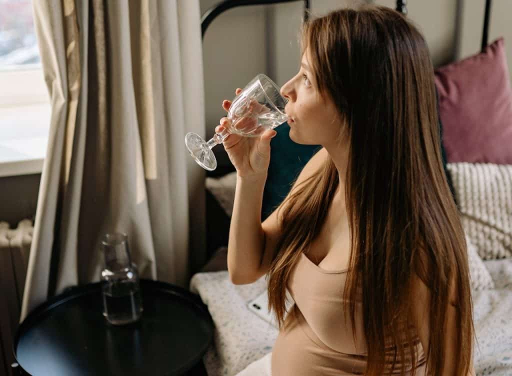 pregnant woman drinking water