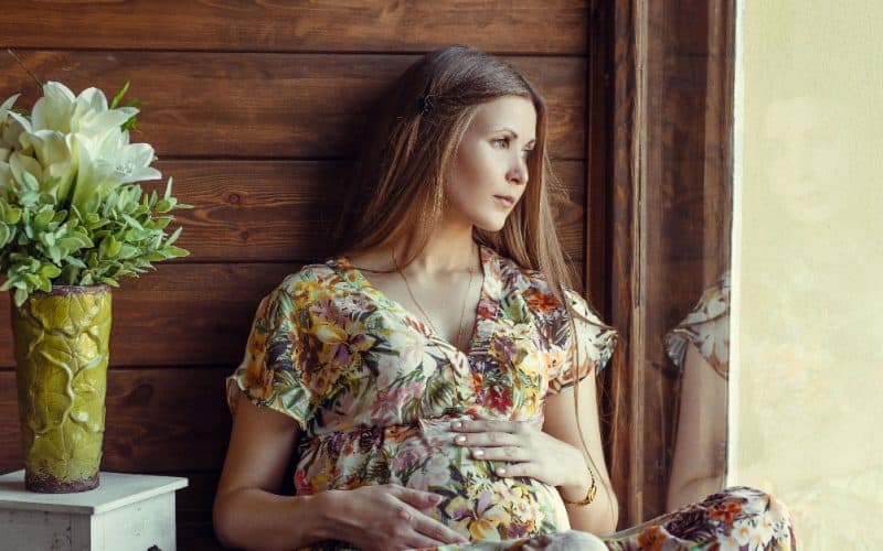 pregnant woman looking out the window