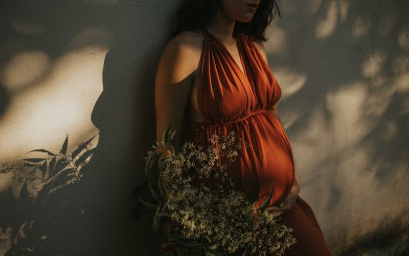 pregnant woman standing on a wall