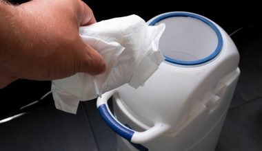 throwing diaper on a bin