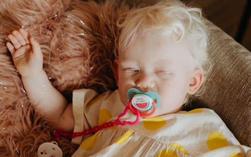 toddler sleeping on sofa