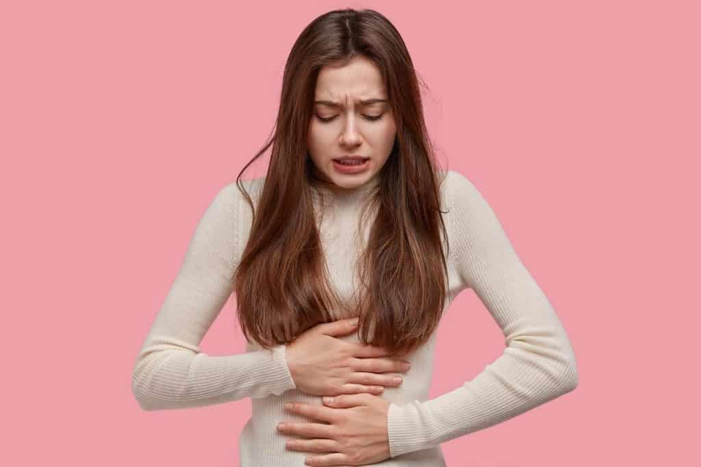woman experiencing pain in her stomach