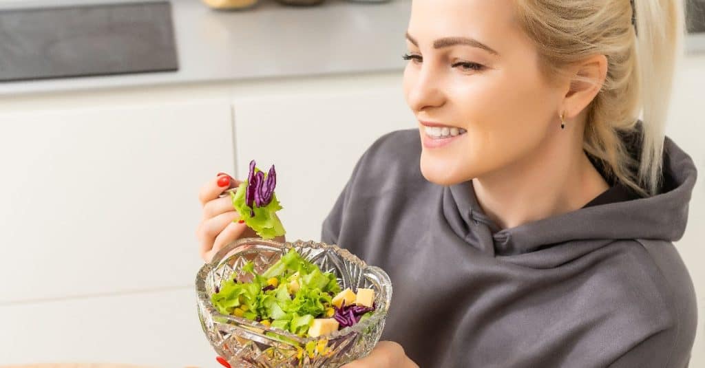 woman holding a vegetable salad