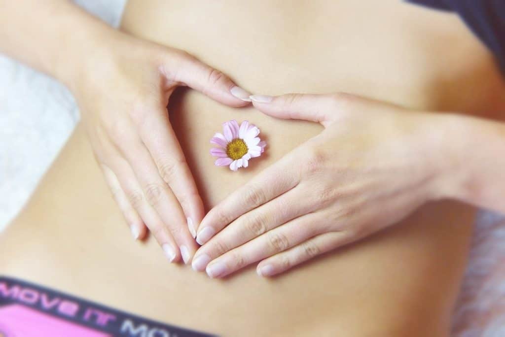 woman with flower on stomach