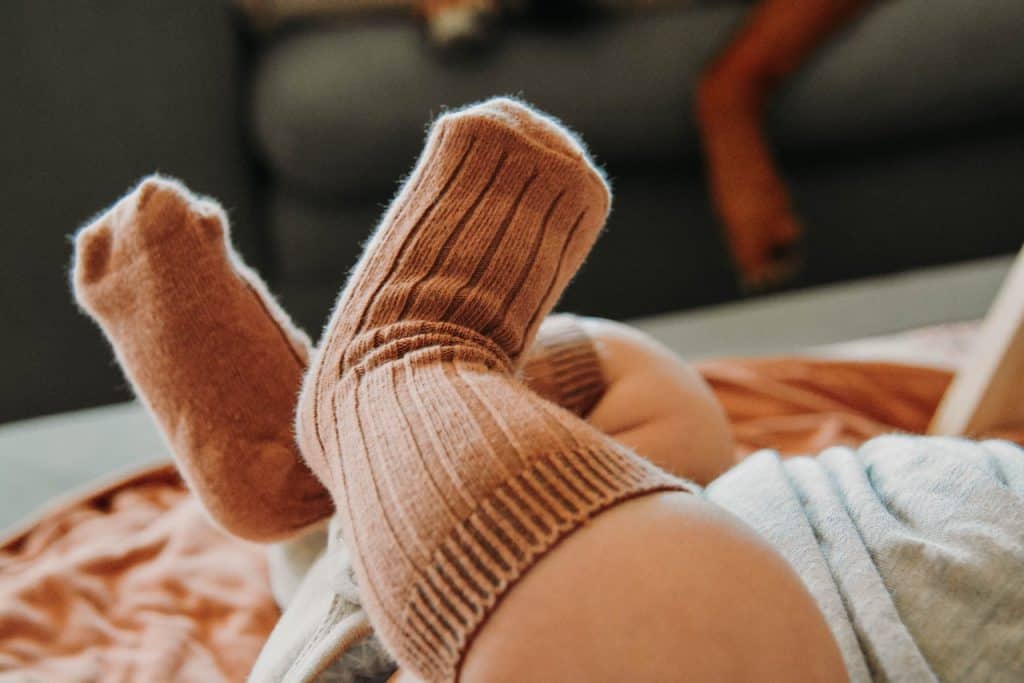 a baby wearing brown socks