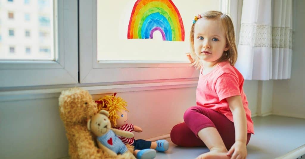 baby girl sitting with her dolls