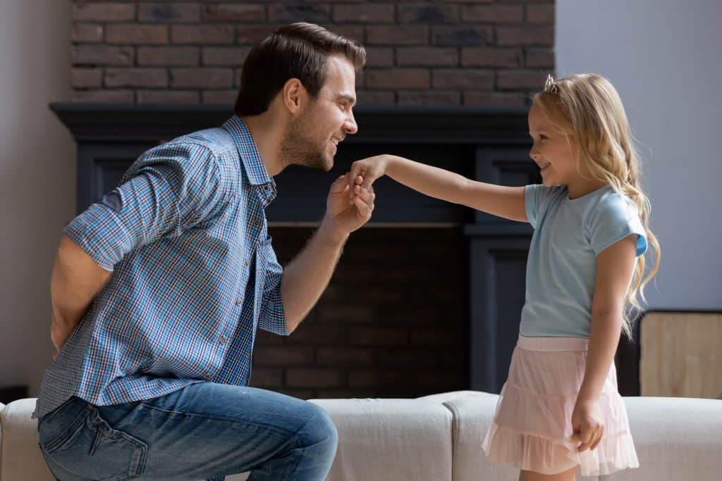 dad kissing daughter's hand