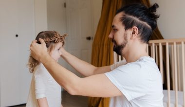 dad putting flower crown on daughter