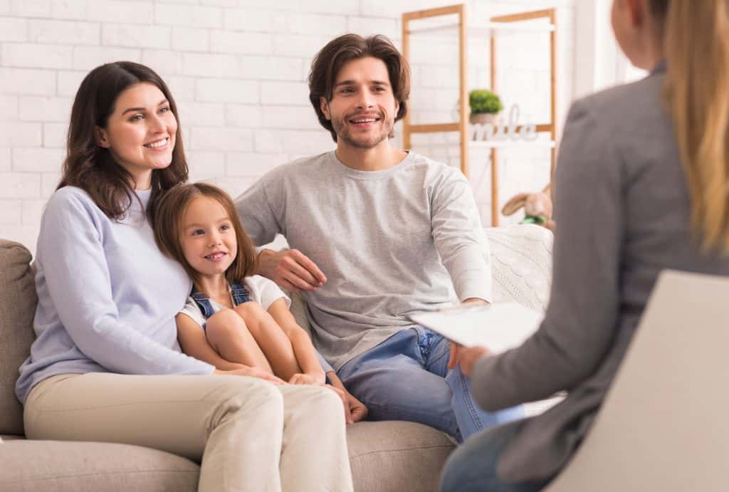 family smiling at a social worker