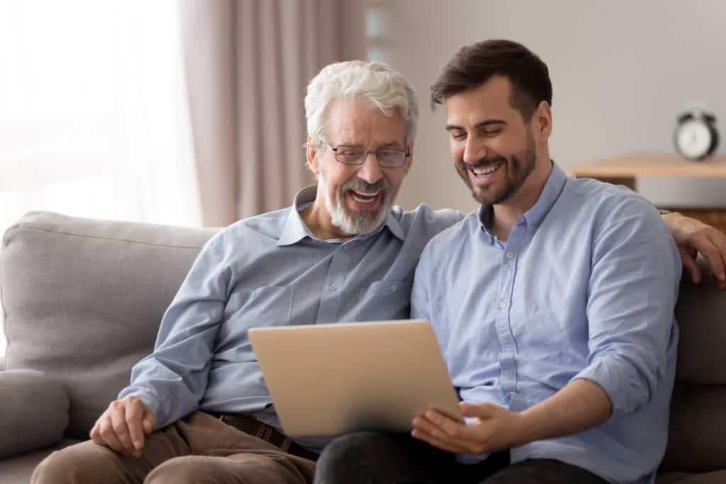 father and son looking at an ipad