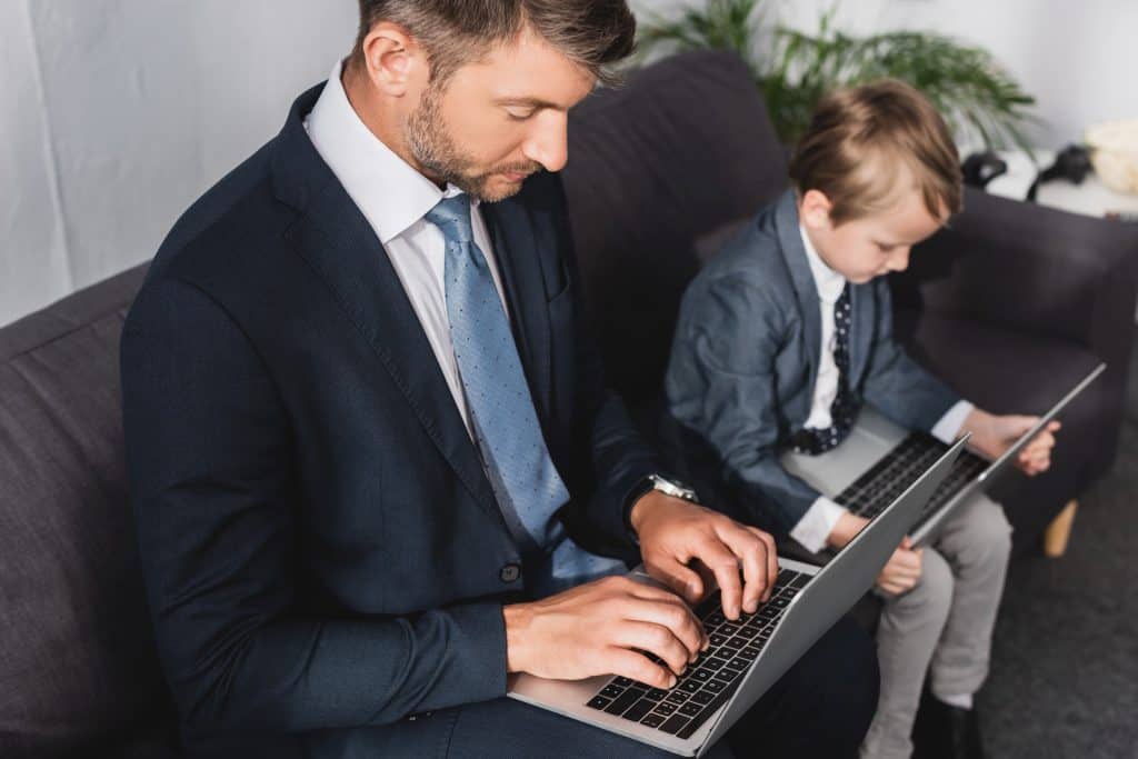 father and son working on laptop