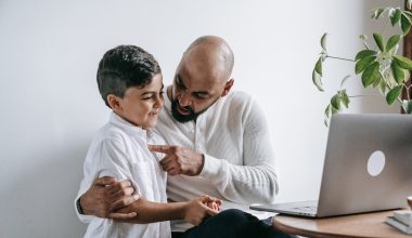 father pointing son's heart