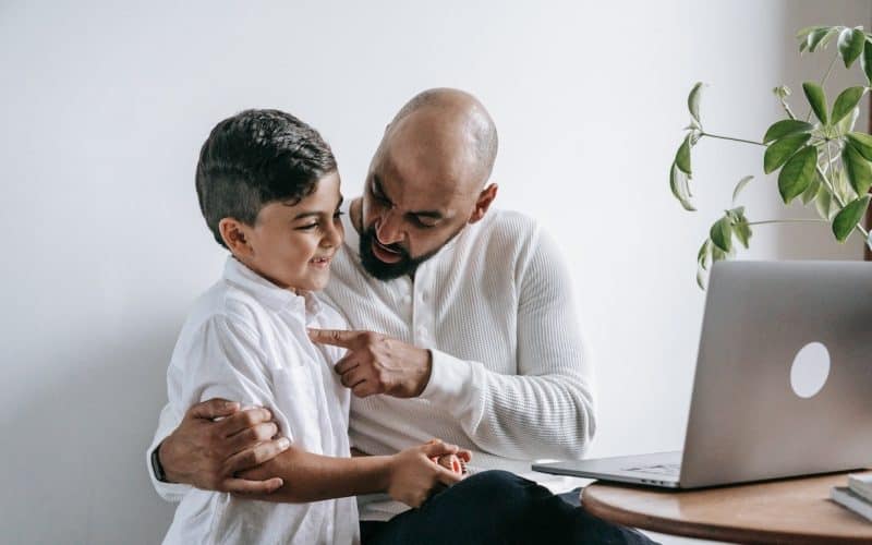 father pointing son's heart