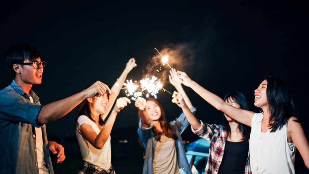 friends playing with light sparks