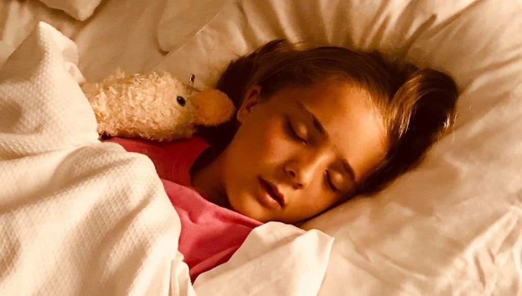 girl sleeping with stuffed toy