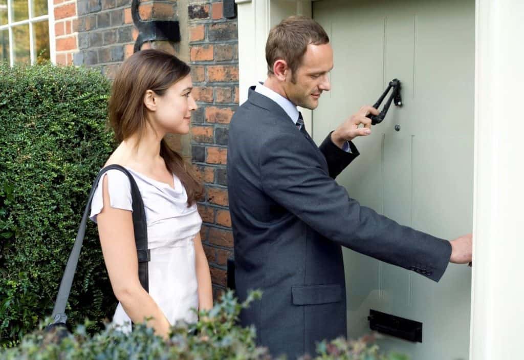 man and woman ringing doorbell