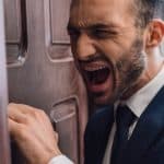 man shouting in front of a door