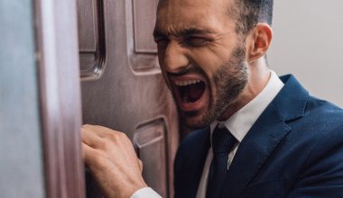 man shouting in front of a door