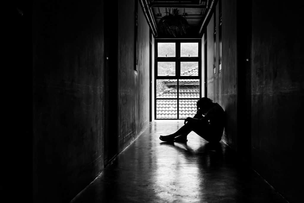 man sitting on a hallway