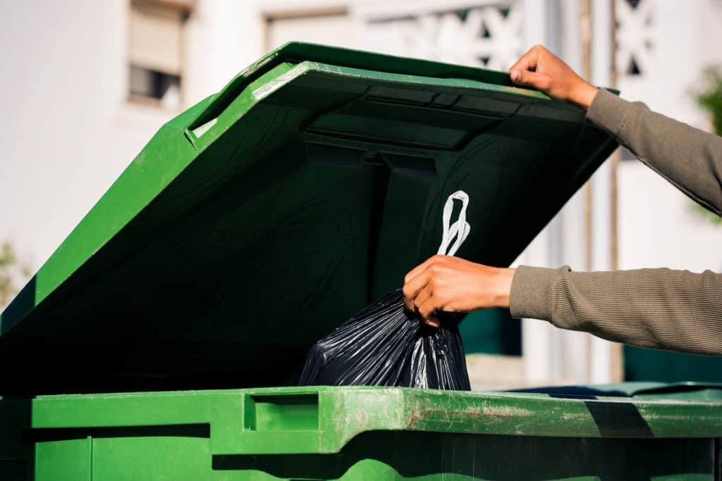 man throwing out trash