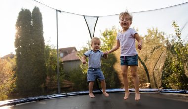 siblings jumping on a trampoline