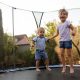 siblings jumping on a trampoline