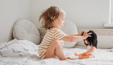 toddler playing with her doll