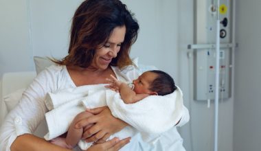 woman holding her baby after birth