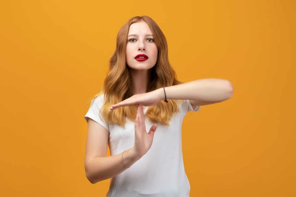 woman making time out sign